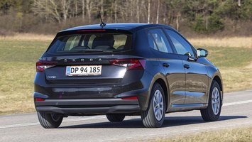 Sort Skoda Fabia set bagfra, mens den kører på en landevej