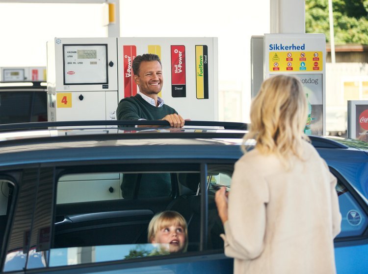 Bil holder på tankstation.