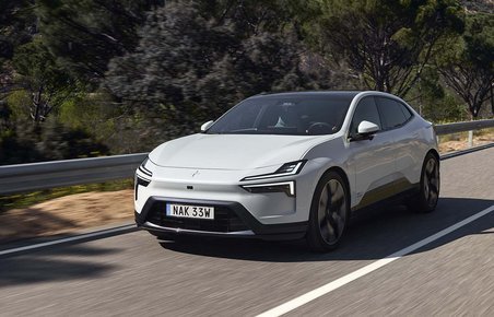 Polestar 4 set forfra, mens den kører på en vej